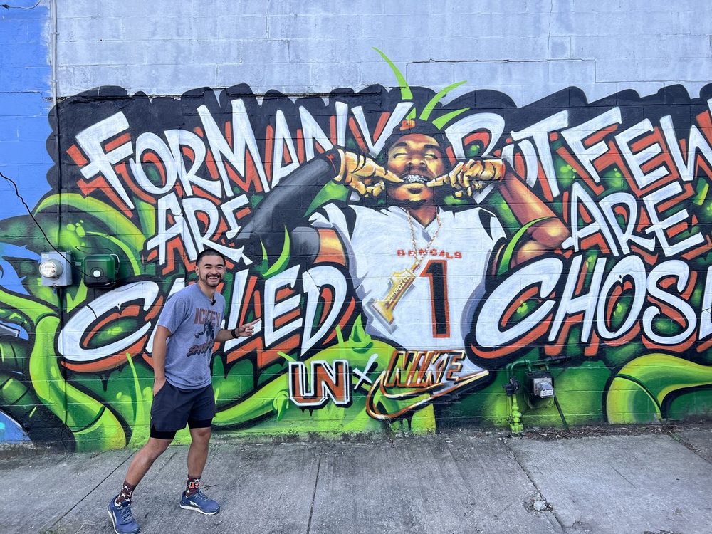 Ian in front of a mural in Over-the-Rhine, Cincinnati