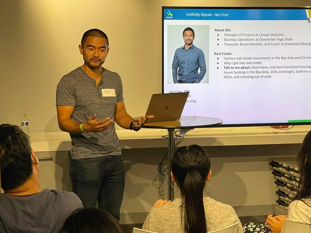 Ian presenting underwriting on a laptop to a room of investors